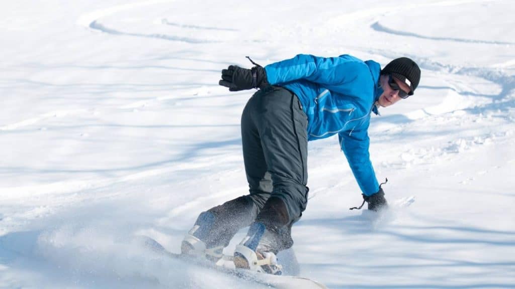Man snowboarding in powder